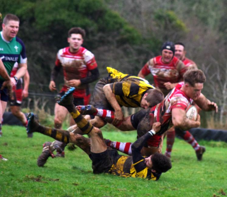 Mariners centre Dan Jenkins is hauled down at Llangwm