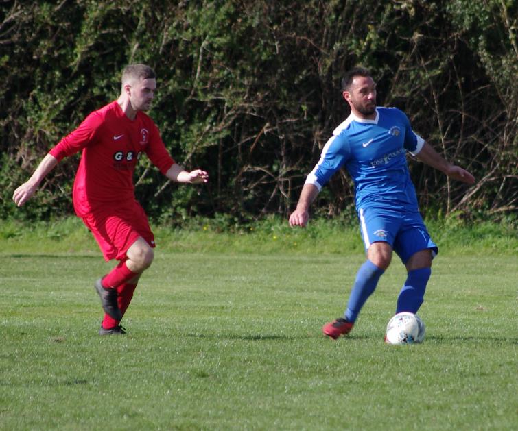 Merlins Bridge goal scorer Peter Thomas on the ball against Pennar Robins