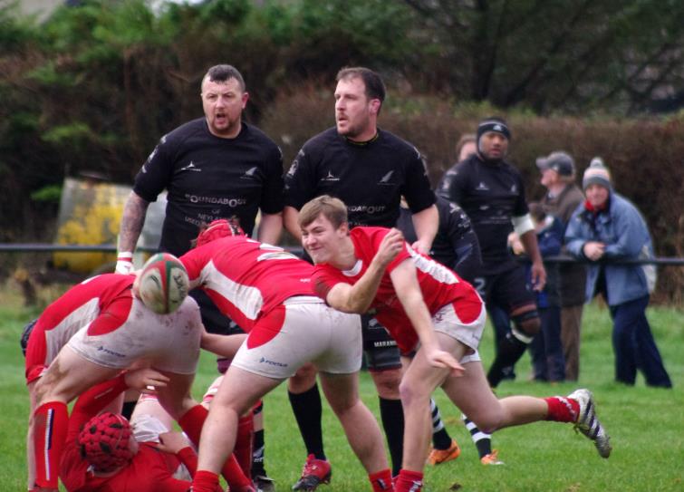 Pembroke scrum half Tom Lewis gets his pass away