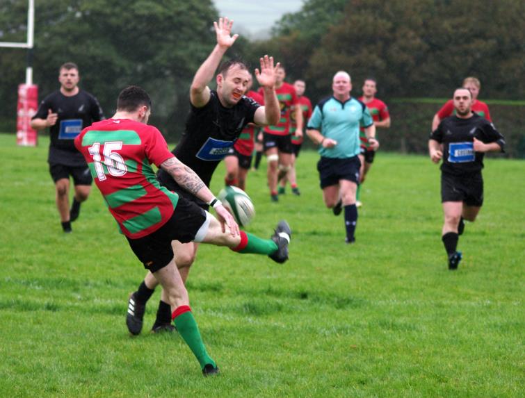 Neyland try scorer Patrick Bellerby charges down a kick 