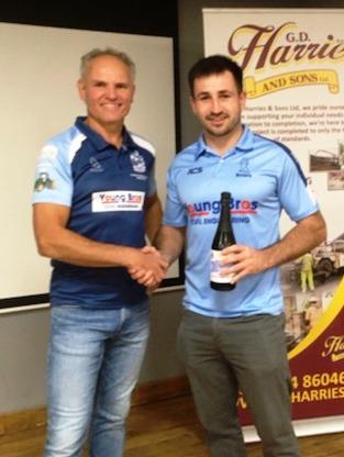Lewys Gibby receives his man of the match award from Andrew Young