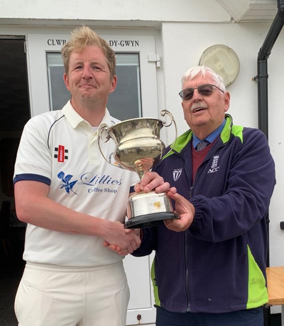 Ben Evans receives the trophy from Trefor Evans