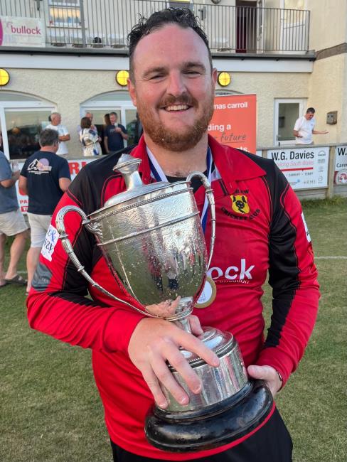 Delighted Carew skipper Rhys Davies with the trophy