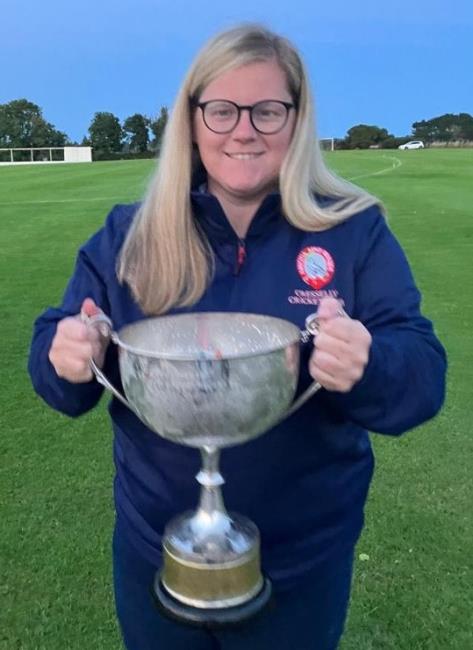 Eleri Williams - holding cricket silverware