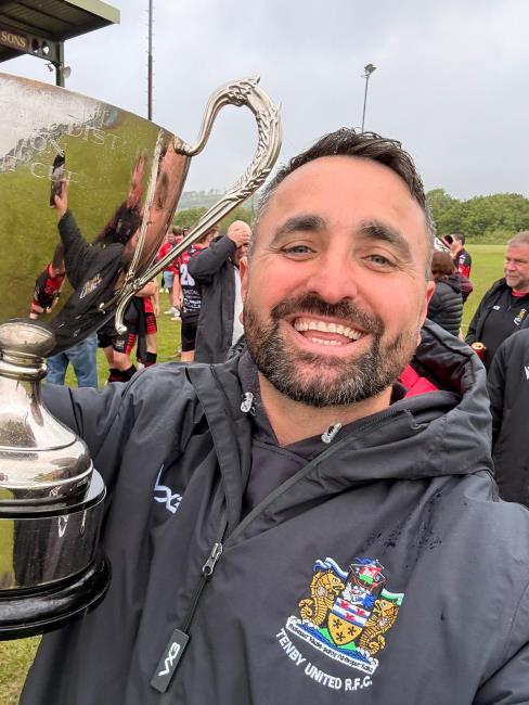  Delighted Seasiders coach Jonathan Evans gets hold of silverware