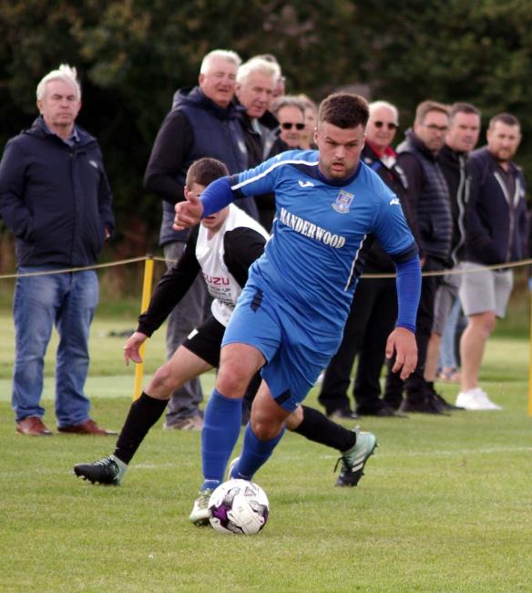 Ashley Bevan presses forward for The Vikings against The Nomads