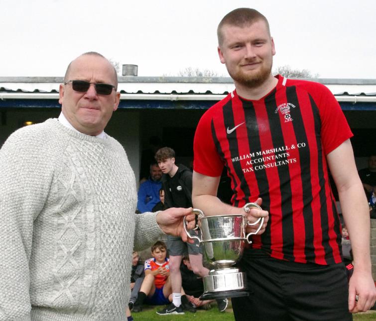 Ceri Morgan presents silverware to Goodwick skipper Scott Delaney