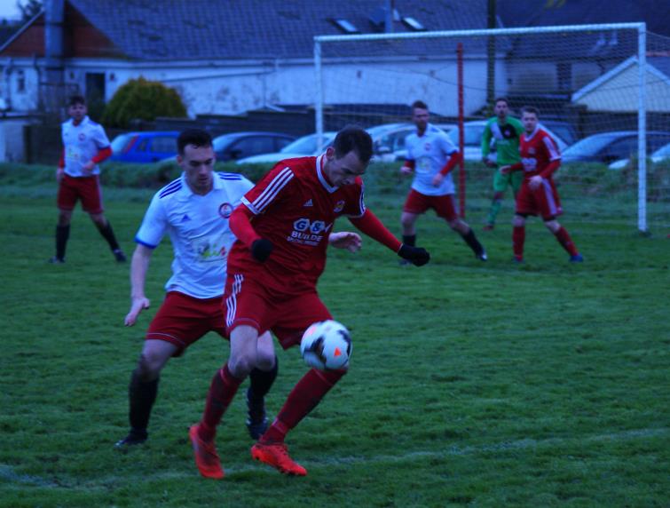 Scott Crawford in possession for West Dragons against Milford United