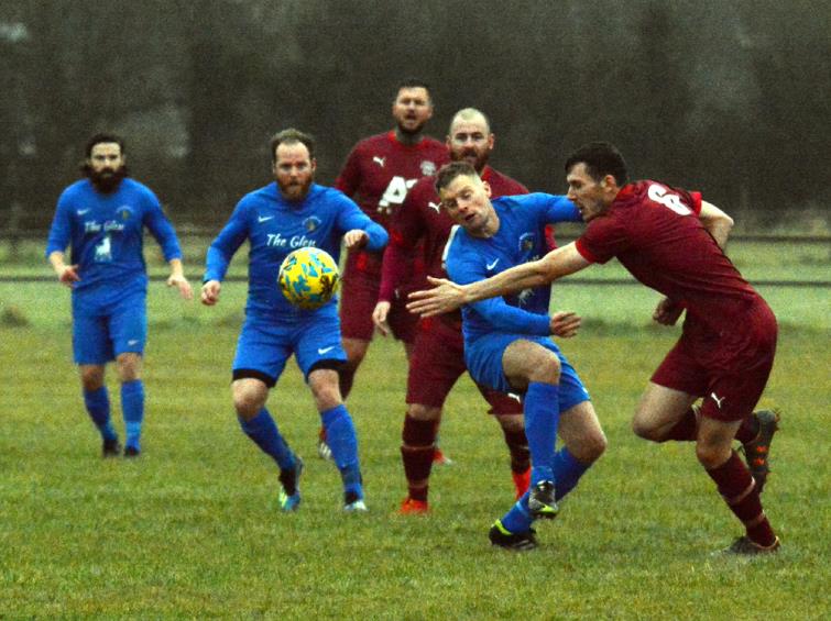 Merlins Bridge midfielder Dai Davies battles for the ball against Ynystawe Athletic