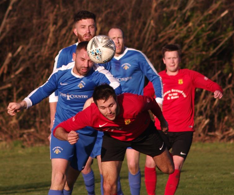 Richard Hughes clears the danger for Merlins Bridge who beat Carew 3-1 at the Racecourse