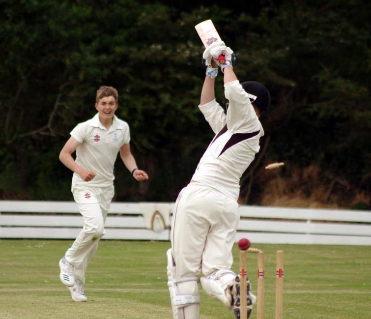 Llangwm teenager Joe Phillips bowls Nick Koomen