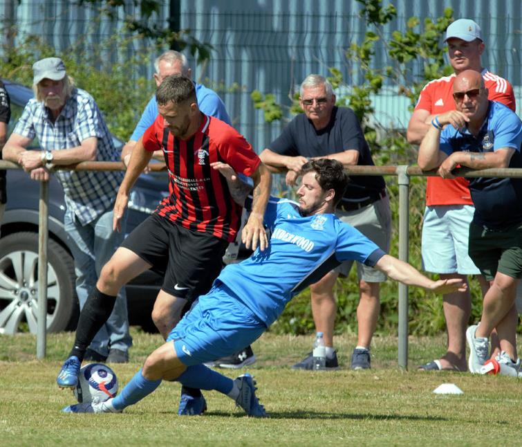 Leon Luby puts in a strong tackle on Jonny Horgan