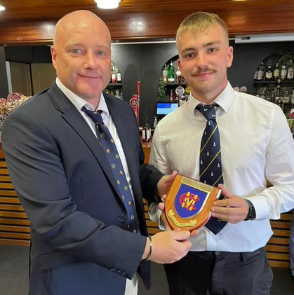 Paul Rees presents an MCC plaque to Hook skipper Aled Phelps