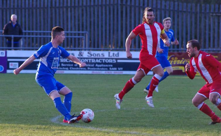 Rhydian Davies plays a through ball