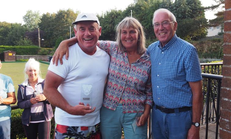 Brian Hearne presents trophy to mixed doubles champions Louis Warren and Lucy Brooker