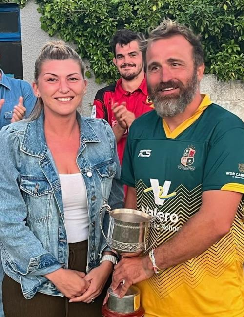 Toby Bradley-Watson receives the trophy from Kens granddaughter Charlene