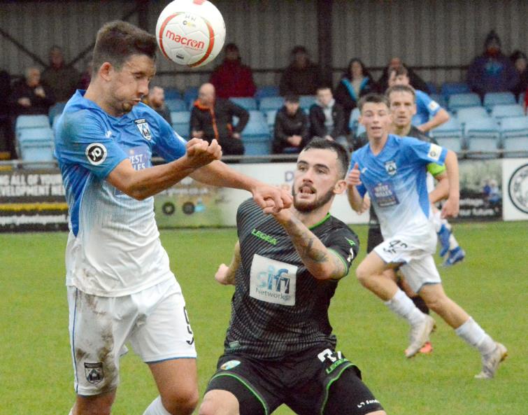 Ben Fawcett clearly wins this header