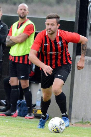 Jonny Horgan on the ball and Nathan Greene standing both netted for Goodwick United