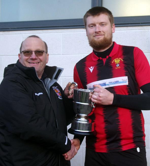 Goodwick skipper Scott Delaney receives the silverware from Ceri Morgan of the Pembrokeshire League Council