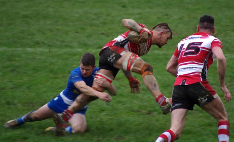 Milford flanker David Round is tackled