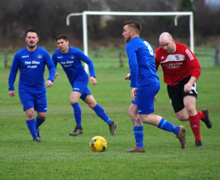 Luke Hayward presses forward for Merlins Bridge against Monkton Swifts