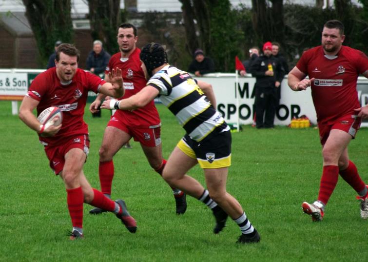 Toby Smith - the outside half uses a strong hand off