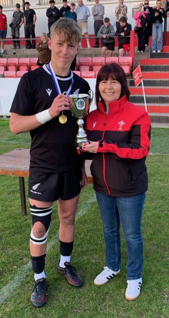 Josh James receives the trophy from Delyth Summons, Distict H represenative on the WRU.