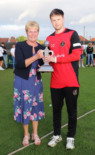 Wendy Davies presents captain Shaun Whitfield of Carew with the winners trophy