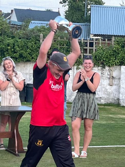 Carew skipper Jamie Heaps receives the trophy
