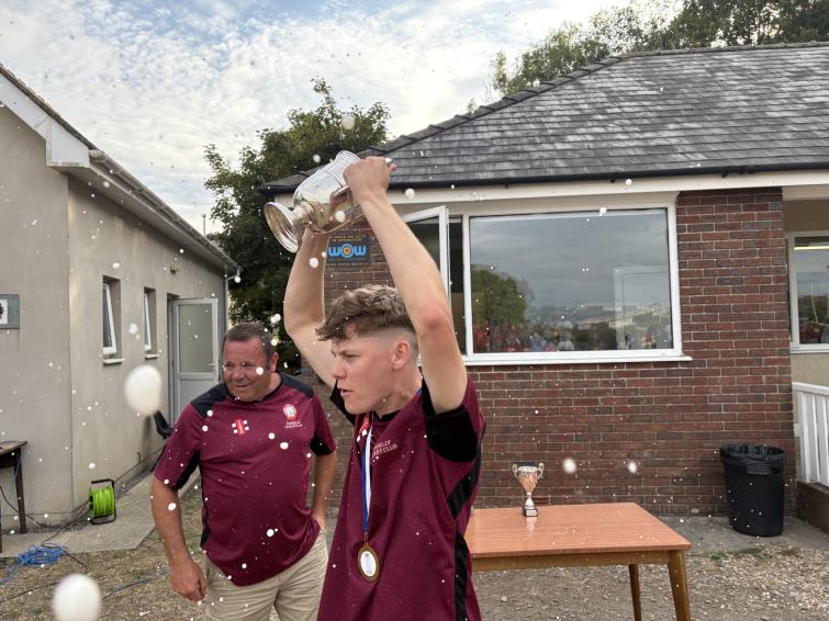 Cresselly skipper Josh celebrates - with a proud man behind him