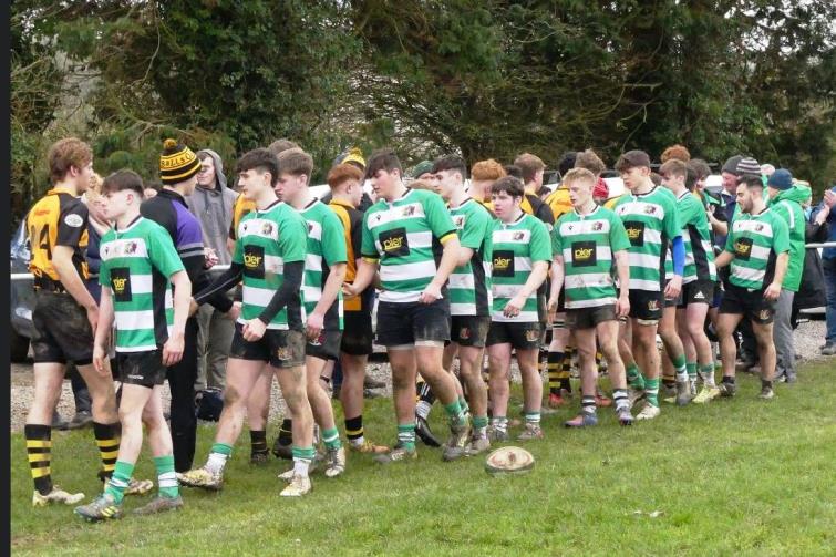 Both teams shake hands as the game came to an end at half time
