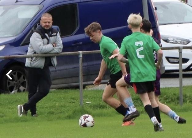 Showing off his football skils in front of a saints rugby man