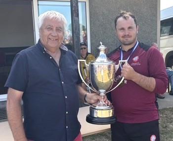 Tom Arthur receives the magnificent trophy from Graham Morris
