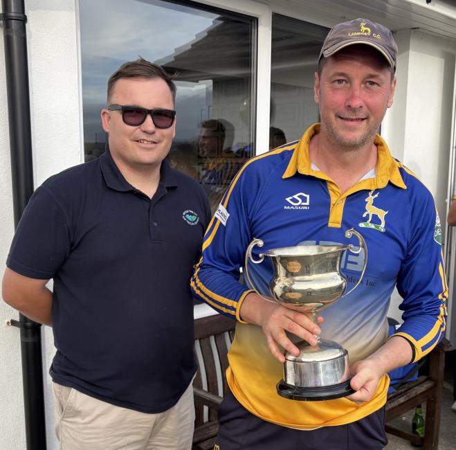 Lamphey skipper David Dredge receives the silverware from sponsores Bysiau Cwm Taf