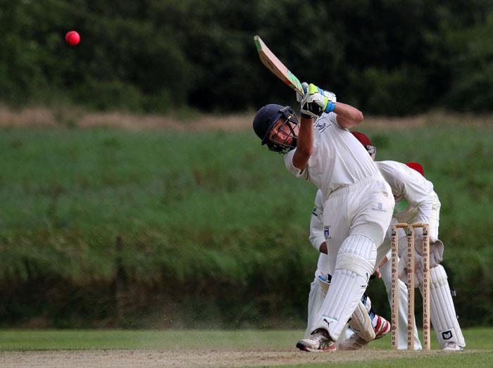 John Mansbridge hits a six