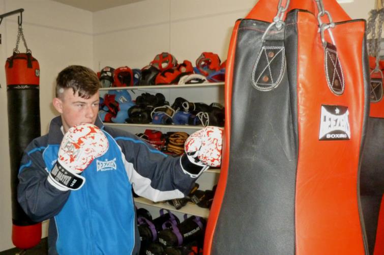 Cameron Barrows punching the bag