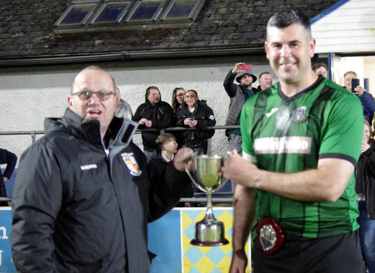 League Council Chairman Ceri Morgan presents silverware to Hakin skipper Jonathan Fawcett