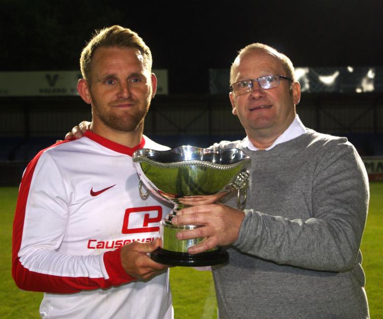 Merlins Bridge captain Chris Ormond receives the Jubilee Cup from Pembroke League Council chairman Ceri Morgan