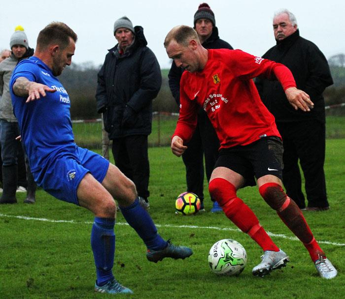 Carew hat-trick hero Jack Christopher takes on Merlins Bridge centre back Chris Ormond