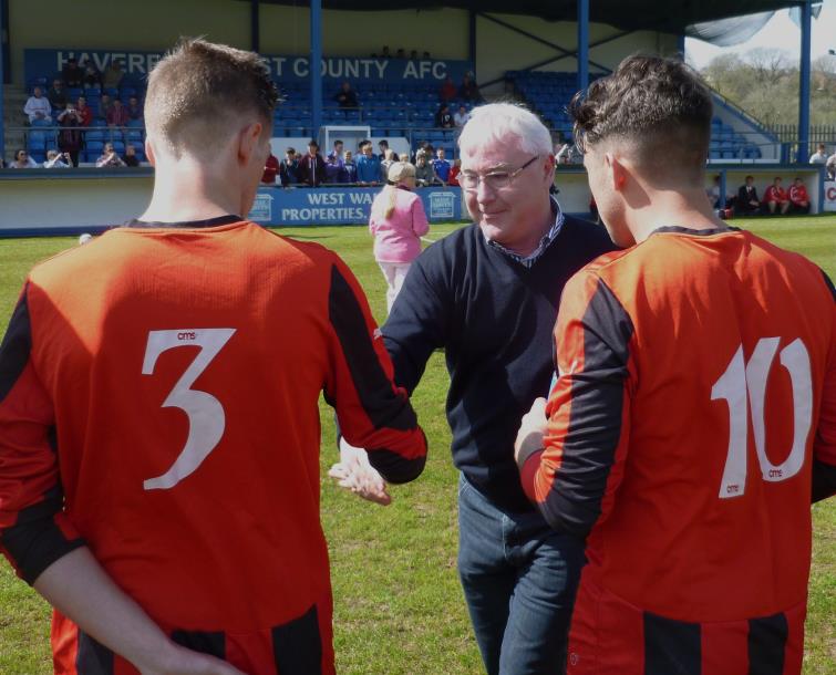 Chris Tansey shakes hands