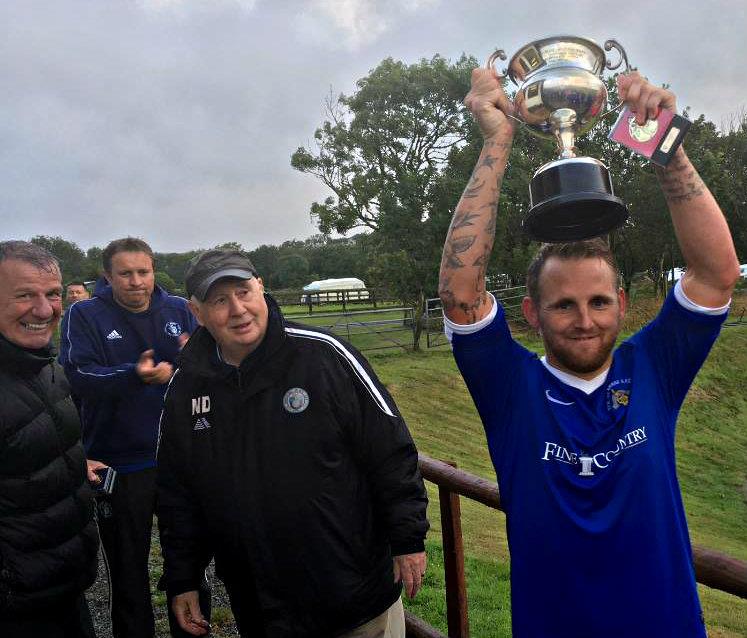 Bridge captain Chris Ormond holds the 2019 Eddie Merry Cup aloft