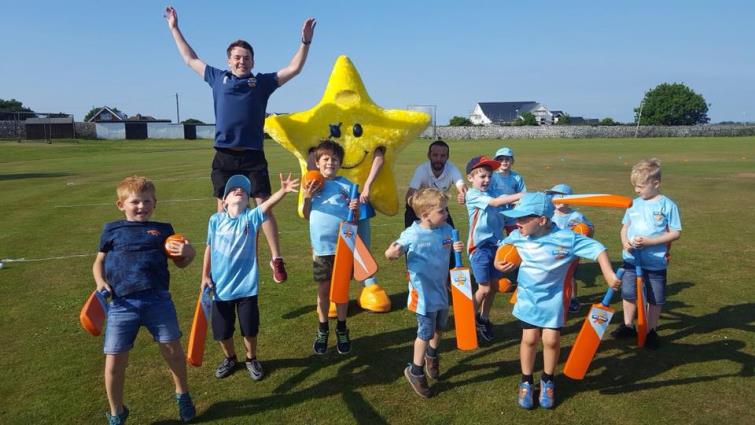 Craig Butland and children are jumping for joy