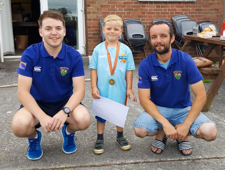 A proud youngster receives his certificate