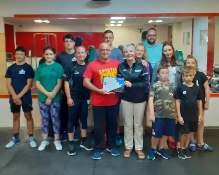 Angela Miles and Weight lifting club members