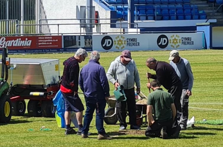 Alan Thomas and ground staff repair the surface