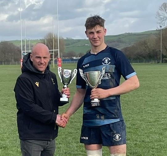 Aled Parry presents the trophy to Aber skipper Henri Michell