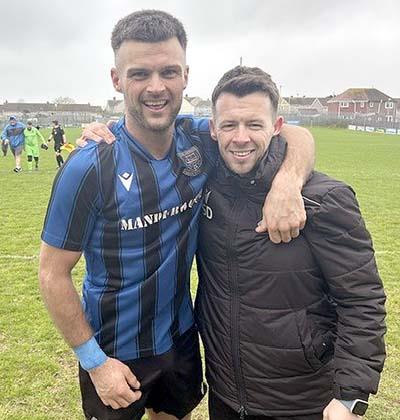 Goal scorer Ashley Bevan and Hakin manager Scott Davies celebrate beating Goodwick to seal the title