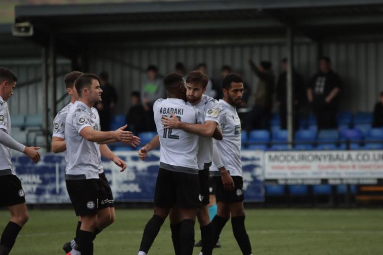 Bala Town two-goal hero George Newell celebrates scoring with teammates