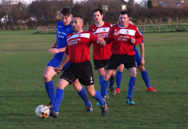 Ben Nicholas plays a back pass