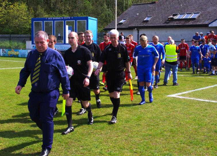 Secretary Brian Hawkins leads both teams out